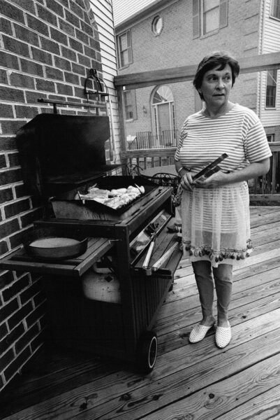 Barbara grilling dinner at home, Alexandria, Virginia