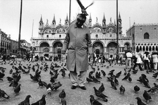 Tourist with Pigeons in Saint Mark’s Square, Venice, Italy